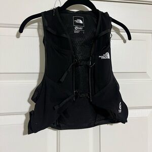 The North Face running vest size large comes with two water hydration packs.